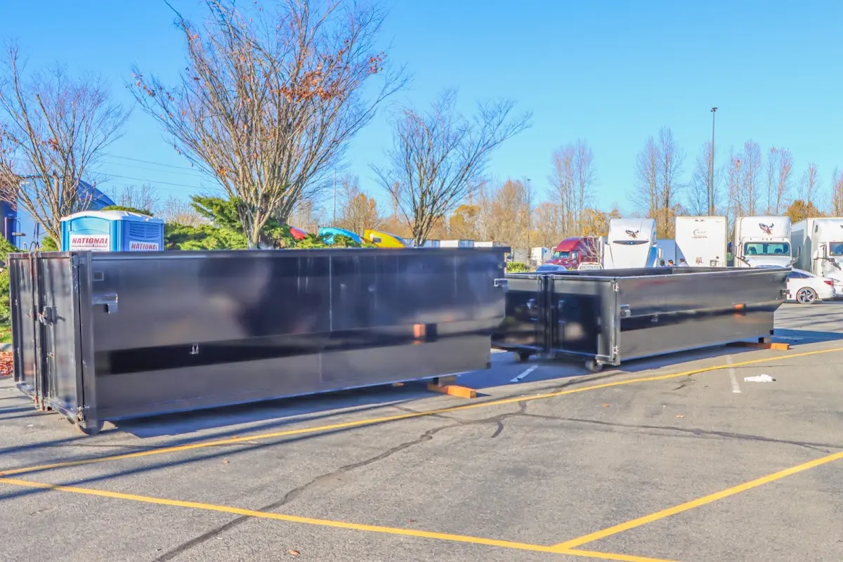 Professional dumpster rental service with roll-off container on residential driveway in Westwood Lakes